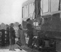 Guard lifting pram onto railbus